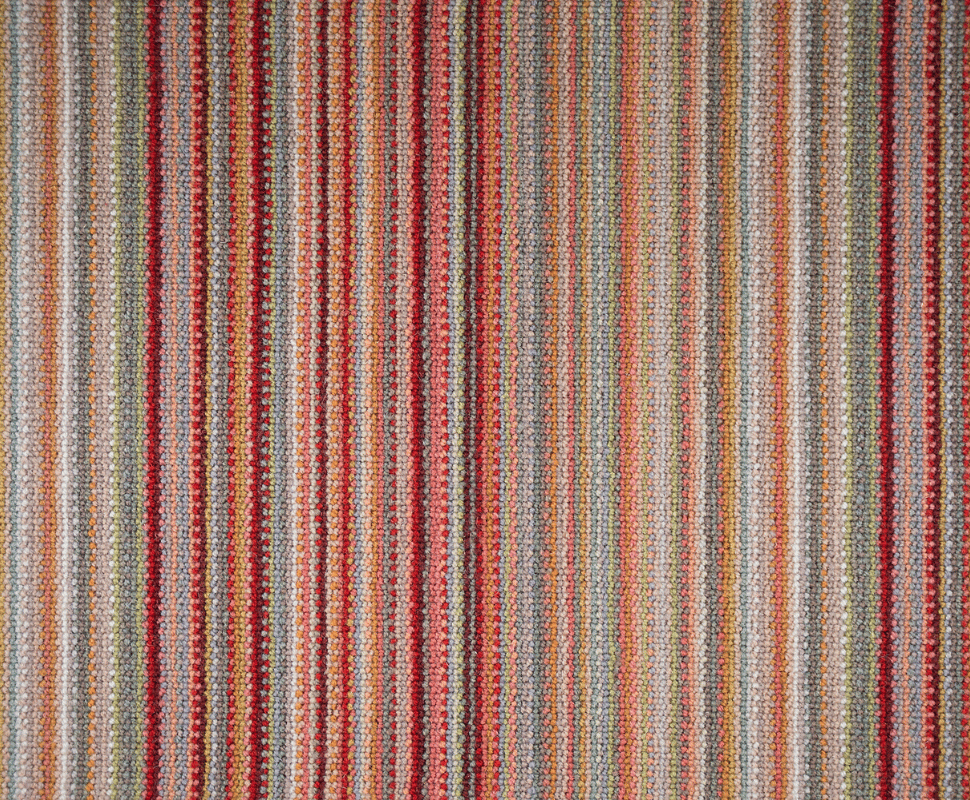 Linear arrangement of warm coral, burgundy, olive green, and beige wool loops forming subtle stripes.