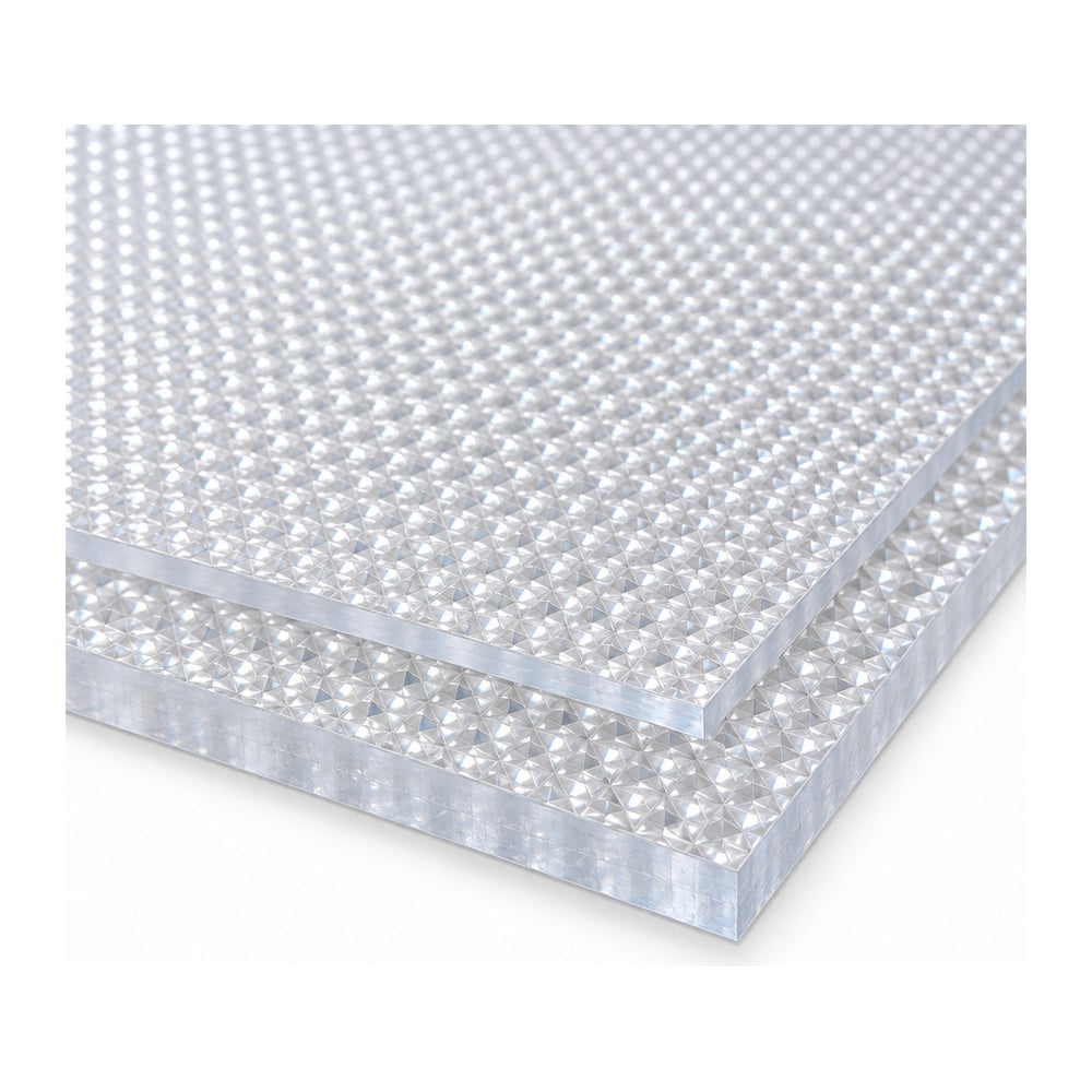 Clear prismatic polycarbonate lighting panels stacked in two thicknesses on white background