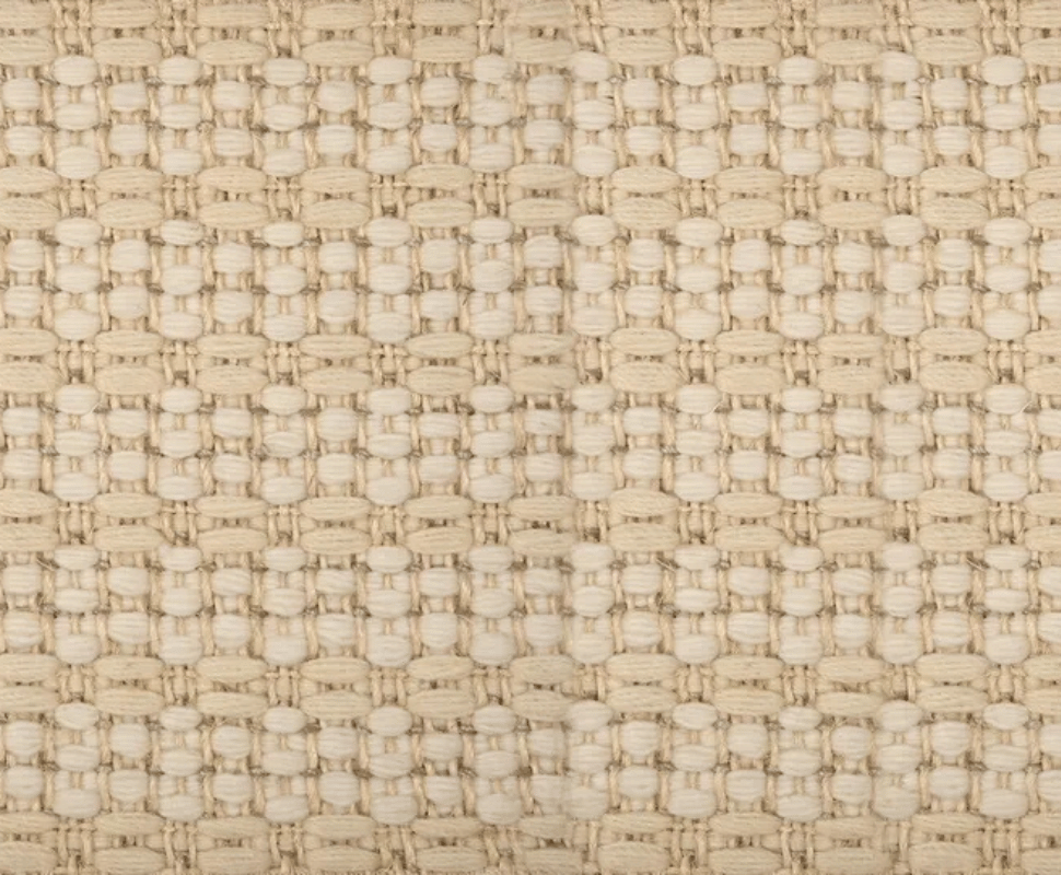 Detailed macro texture shot highlighting chunky ivory wool nodules grid-woven with gold sisal threads.
